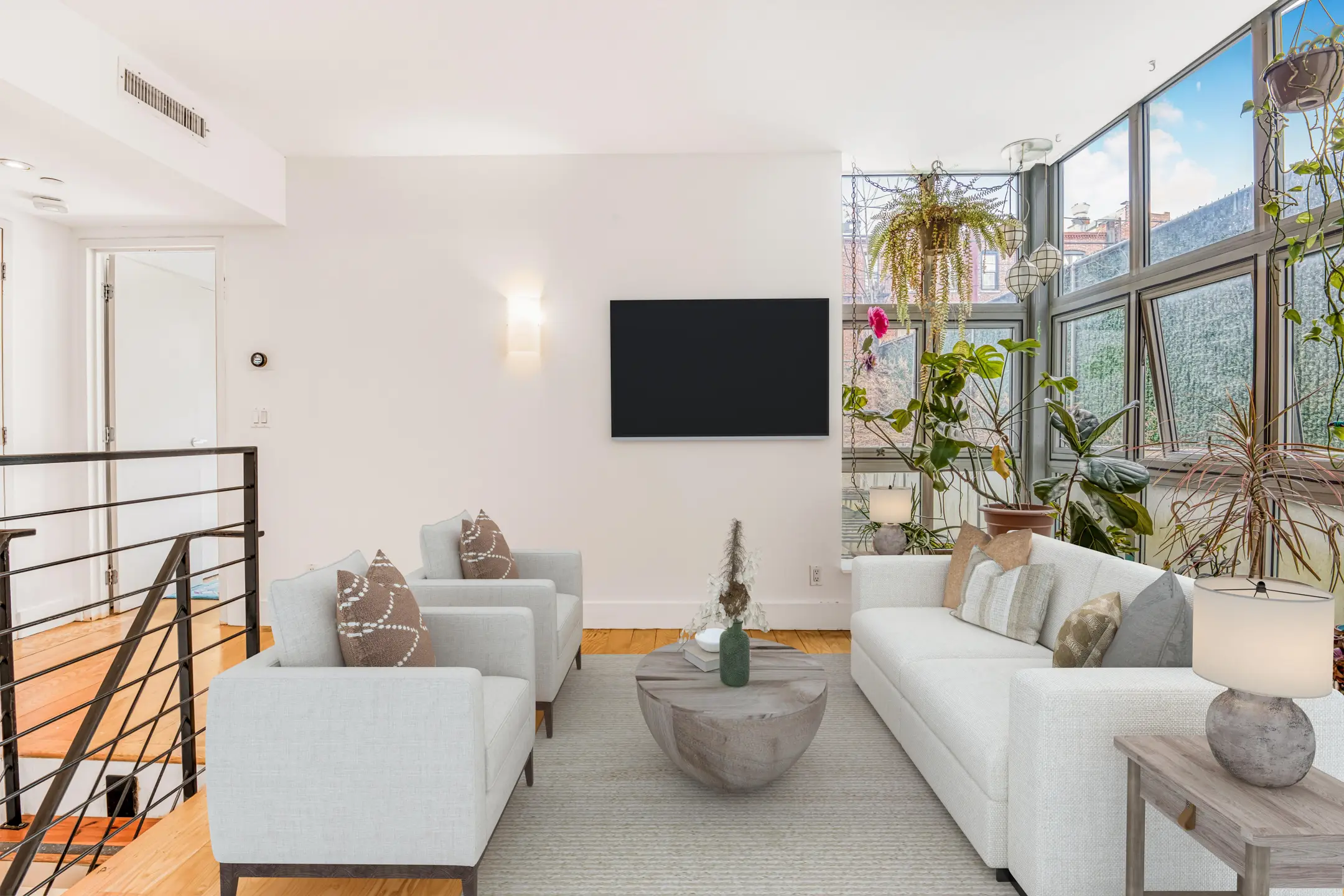 Bright modern living room with white sofas
