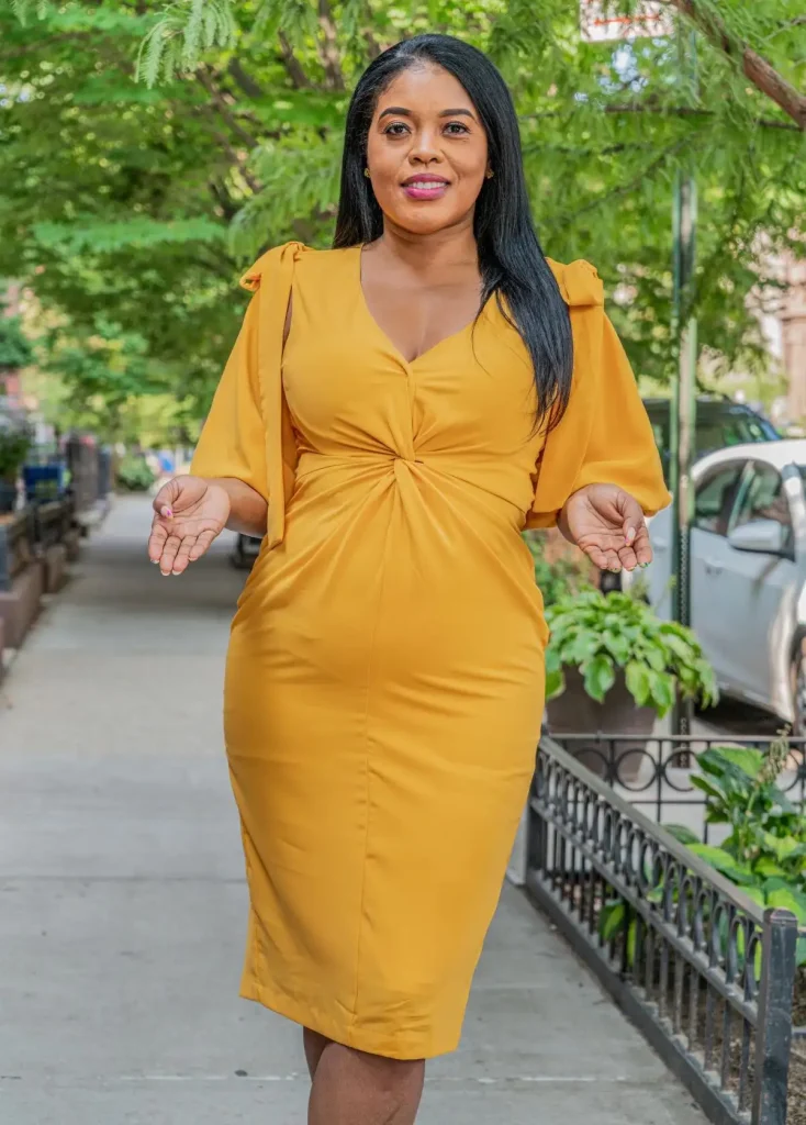 Woman in yellow dress standing outdoors